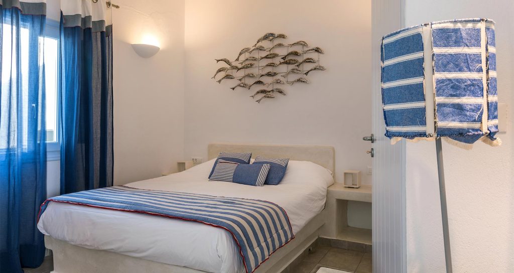 apartments in santorini with comfortable bedroom bluedolpins